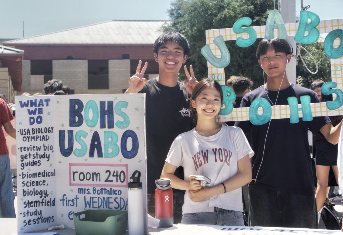 Ryland Chang ('28), Raina Kim ('28), and Brandon Wang ('28) behind their table for USA Biology Olympiad Club (USABO) Sept. 8.