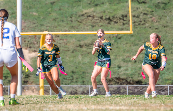 Quarterback Bella Ramirez ('28) looks upfield as Whitney Sneddon ('28) and Ryleigh Jones ('26) sprint ahead. Girls' varsity flag fell to the visiting Highlanders 27-7 Sept. 15. 