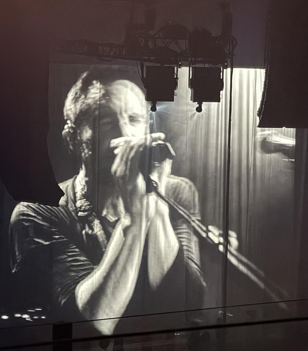NIN frontman Reznor performs the band's biggest hit, "Closer," while projected onto the main stage's white curtains. 