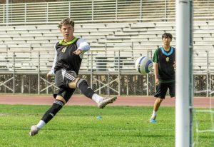 Jack Penalosa ('28) takes a shot during a boys' varsity soccer practice. The sophomore is one of 14 newcomers on the varsity roster.