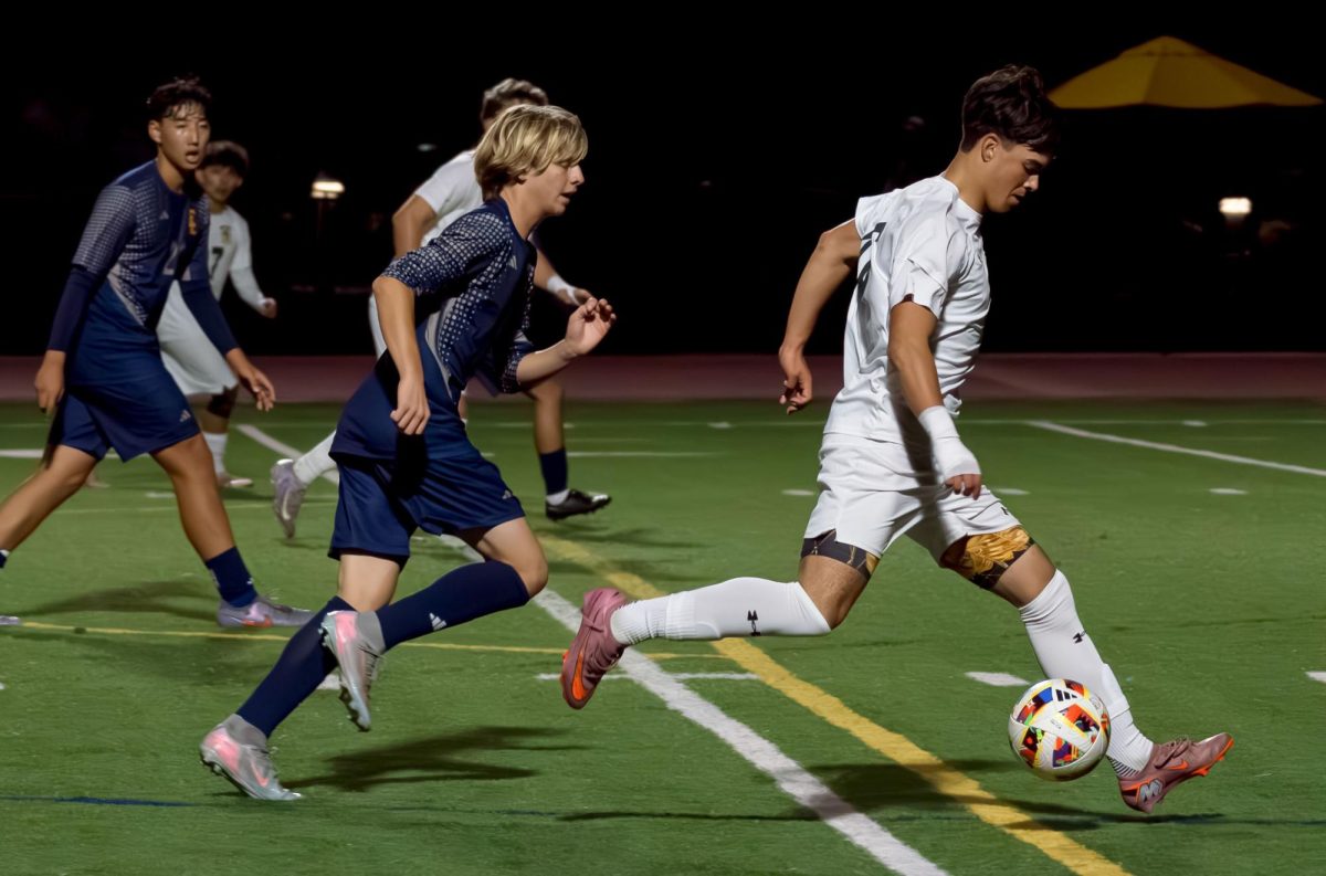 Colin Garcia ('27) races past Crean Lutheran defenders in the second half of the boys' varsity soccer scrimmage in Irvine Nov. 19.