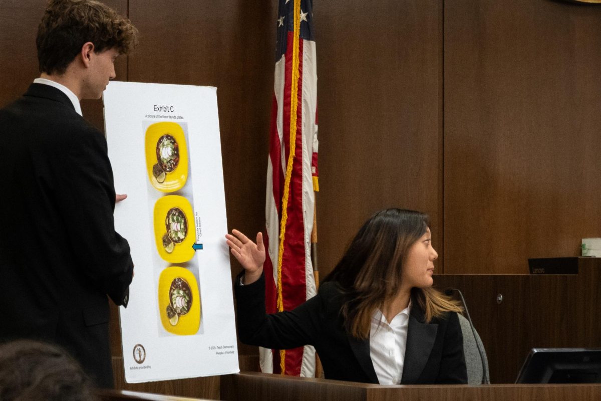 Questioning attorney Sam Johnson (‘26) conducts the direct examinations of Detective Rio Sacks, a witness played by Allison Chun (‘28), and presents the prosecution’s case through exhibits, tangible proof that has been documented, Nov. 20.