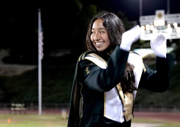 Drum major Aimee May ('26) leads the Wildcat Entertainment Corps marching band in the stands during the varsity football Homecoming game Oct. 10.
