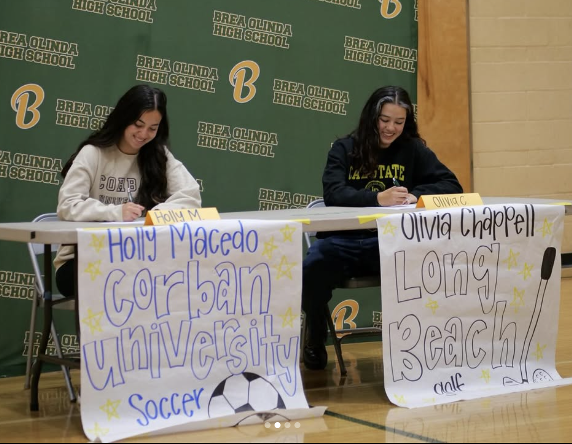 Holly Macedo ('25) and Olivia Chappell ('25) sign their letters of intent in the auxiliary gym, Feb. 26.
