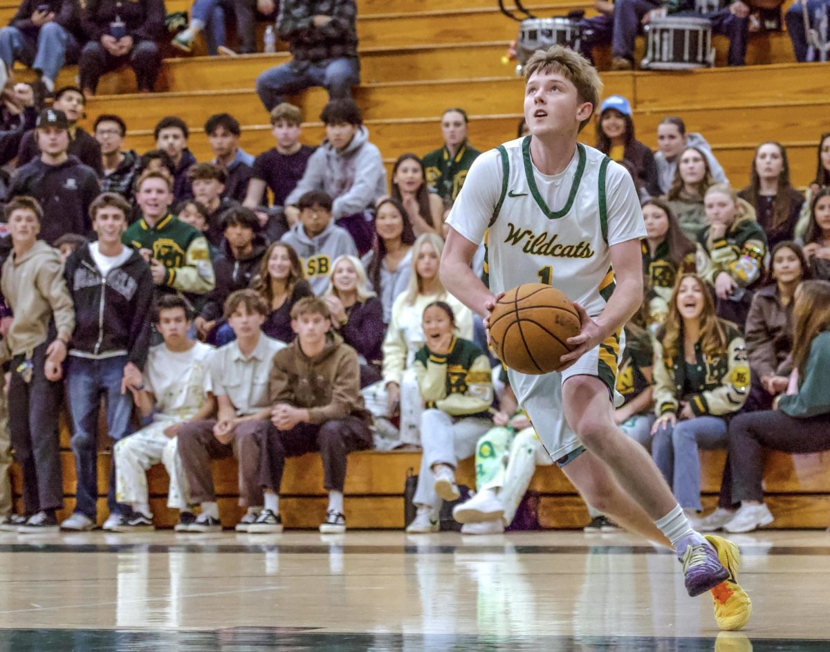 Wildcats' point guard Nick Chamberlain ('26) drives to the basket for a layup for two of his team-high 14 points.  