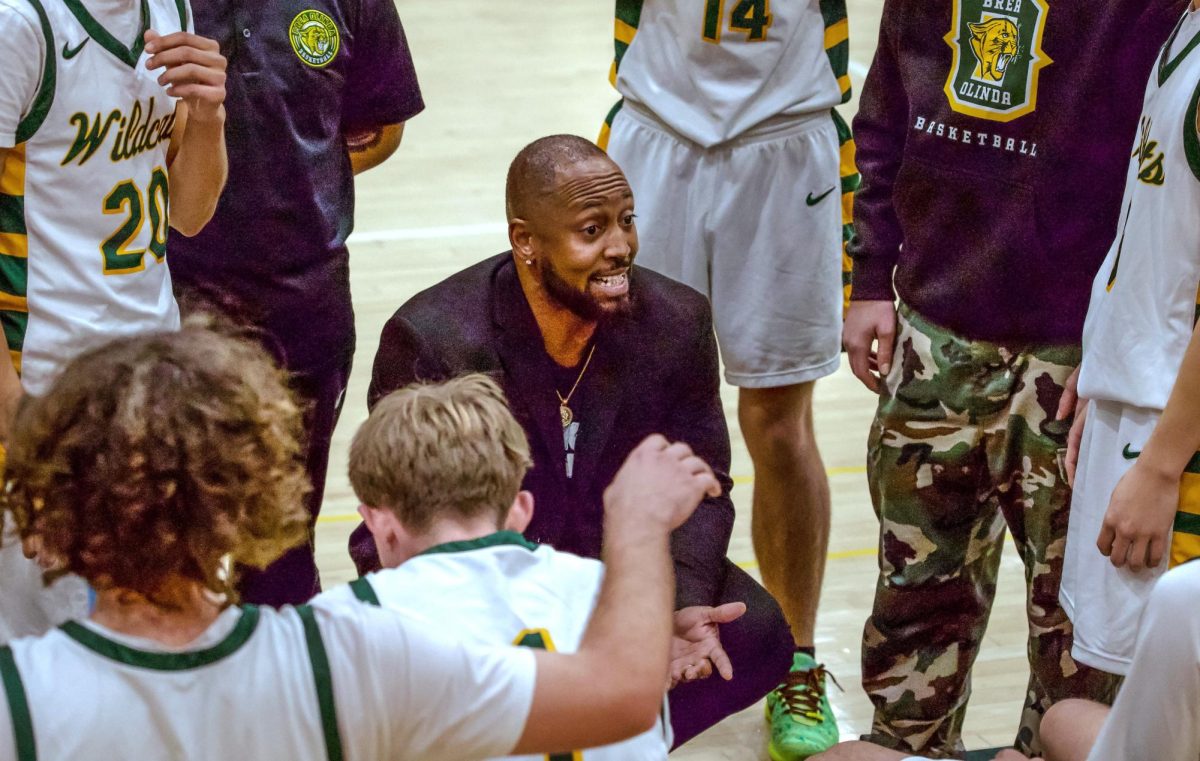Head coach Frederick Bernard talks to his team during a timeout.