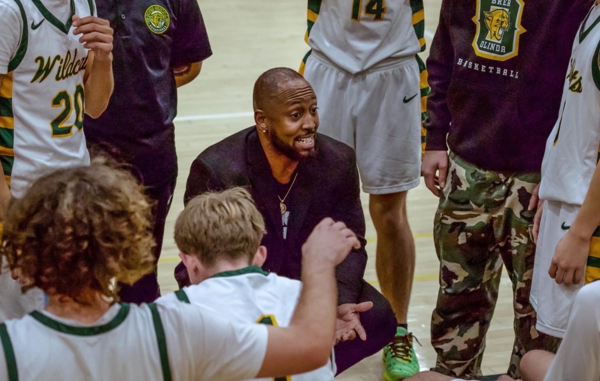 Head coach Fred Bernard talks to his players during a timeout. 
