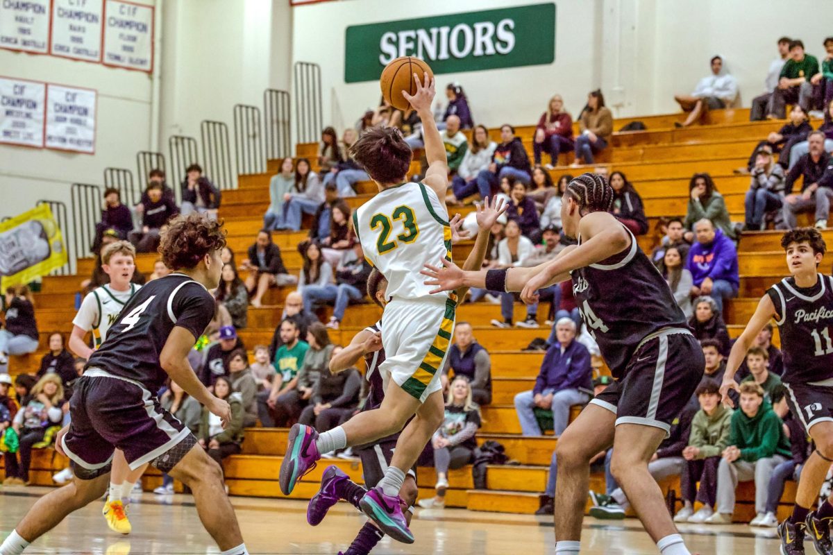 Ryan Chang ('27) drives into the Pacifica defense and kicks the ball out. Chang contributed four points in the contest. 