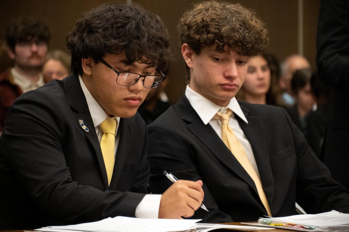 Prosecution co-counsel Sam Johnson ('26) glances at closing attorney Aiden Duenas' ('26) closing argument, which is written each round based on facts present in-trial, at the Orange County Central Justice Center Jan. 22.