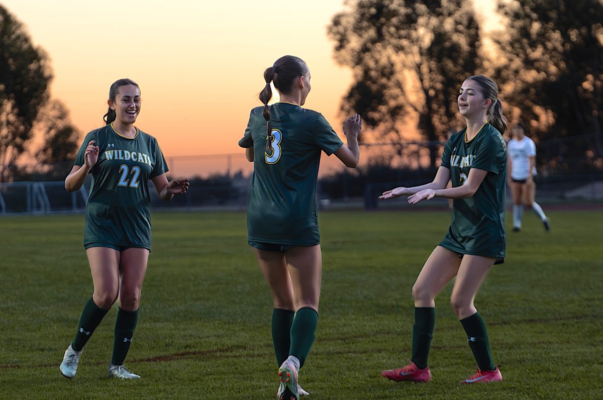 Ashley Wolfson (‘26), center, celebrates with teammates Mia Sims (‘28), left, and Bell Jansen (‘26), right, after scoring the game-deciding goal in the first half. 