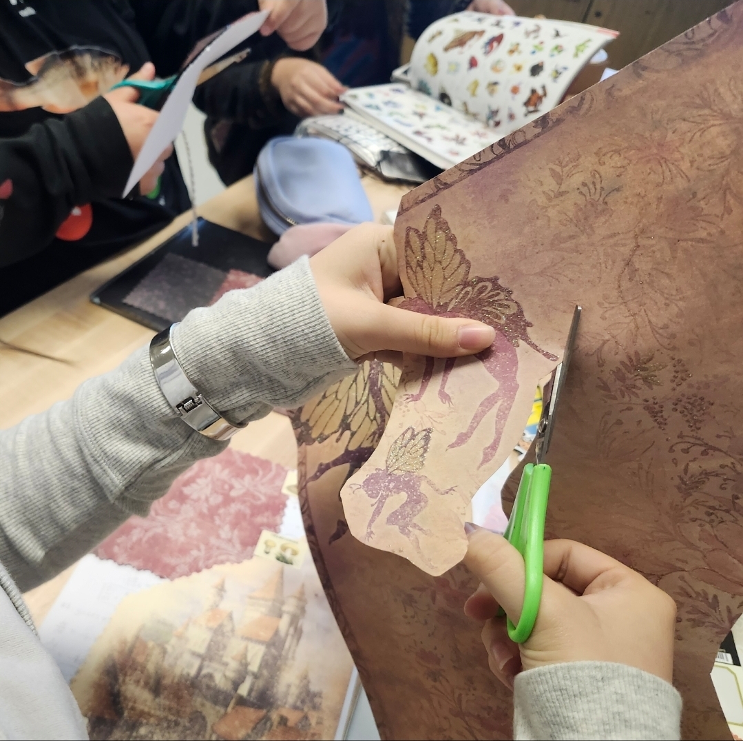 A member of  BOHS Scrapbooking Club cuts out an image for her scrapbook during a Jan. 28 meeting. The club -- which promotoes self-expression and mental wellness through creativity -- meets every other Wednesday at lunch in room 113.