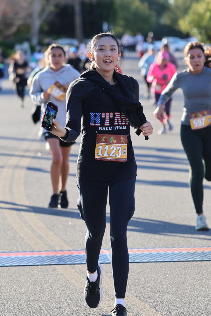 Brea 8K participant Angelica Cruz records herself finishing the race.