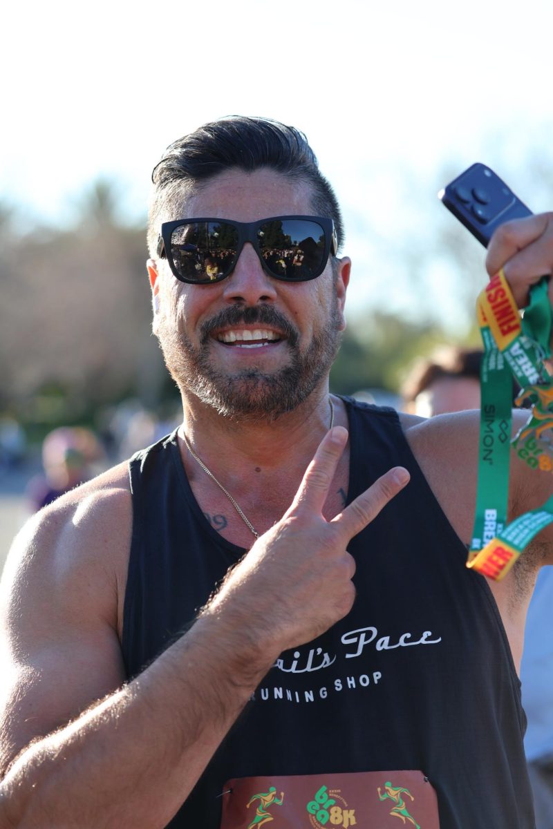  A Brea 8K participant poses with his medal.