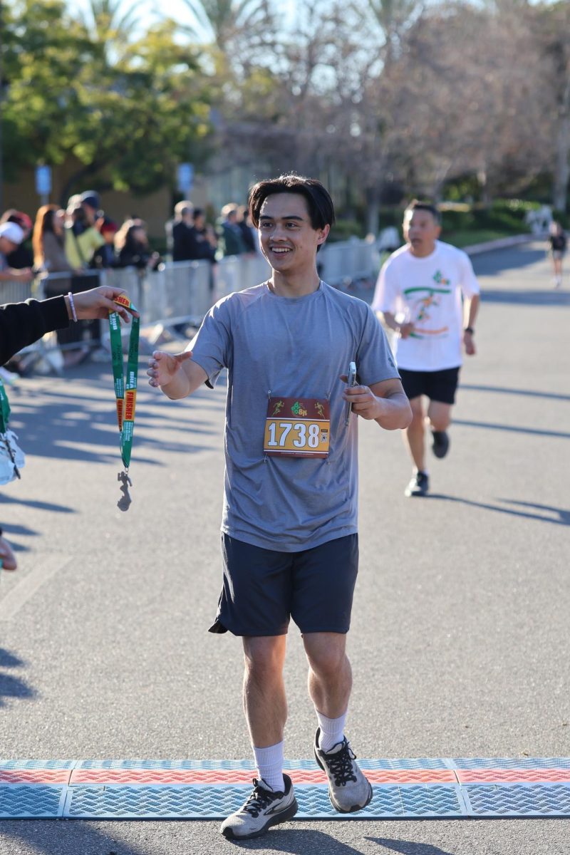 BOHS alumnus Nick Clements (‘23) receives his medal after crossing the finish line.
