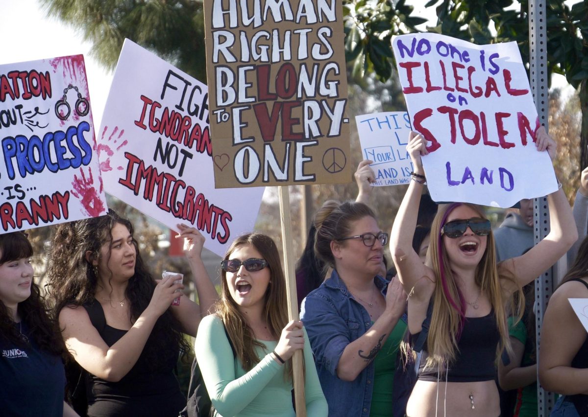 Holding up posters with messages that stand in solidarity with immigrant families, BOHS students protest in front of the Brea Civic Center. 

