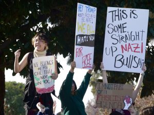 Cadriel Ta ('28) delivers an anti-ICE speech to fellow protesters holding up hand-made signs at Brea's Civic Center during a student-led walkout Feb. 6.