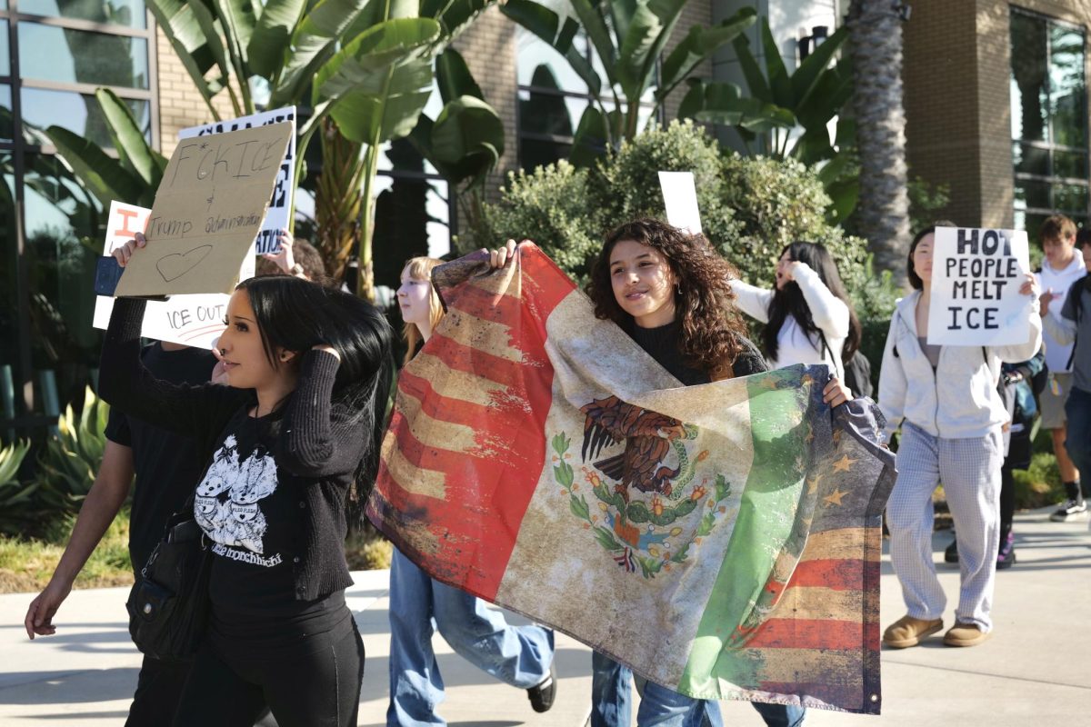 Emily Paez (‘28) holds up a flag displaying a blend of Mexico and America as she protests against ICE at the BOHS student-led walkout Feb. 6.