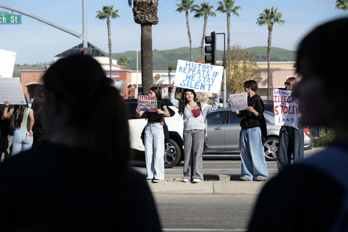 Mylie Cervantes ('29) holds up a sign at the protest in front of the Brea Civic Center. 