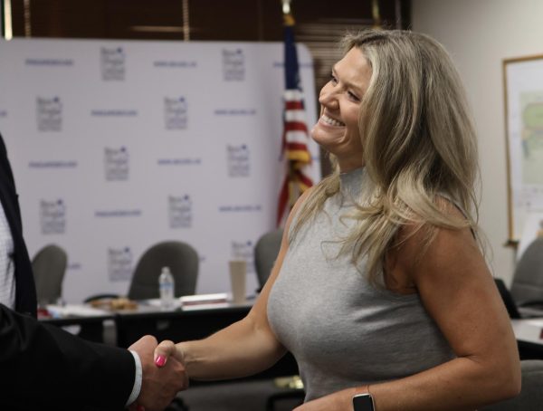 A BOUSD board meeting attendee congratulates Natalie Johnson. Johnson was appointed to represent BOUSD Board of Education Trustee Area 4 on April 20.