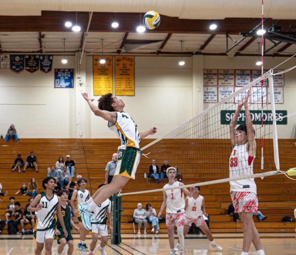 Outside hitter Jeremiah Ammermann ('26) rises for a kill over a Fullerton player. 