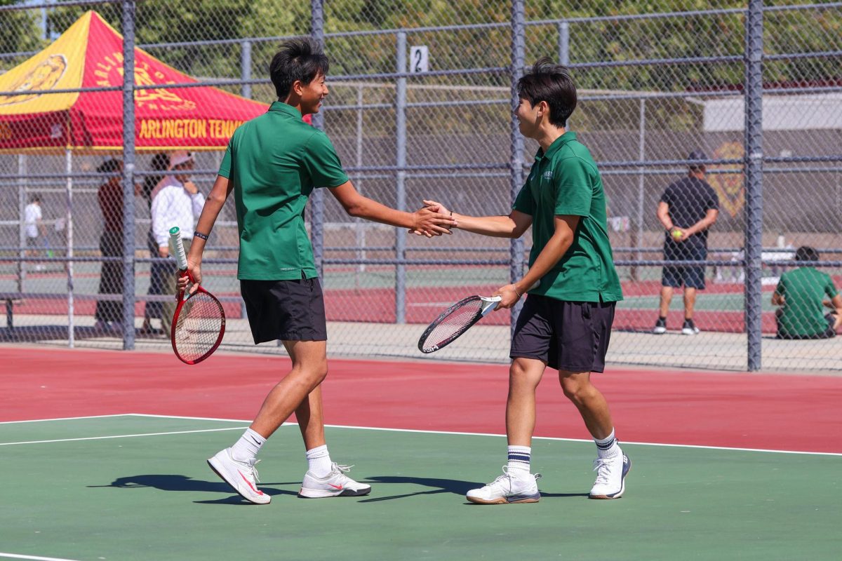 2 Sean Yoon ('26) and Joshua Kim ('28) celebrate a point victory against Arlington's Doubles No. 1.