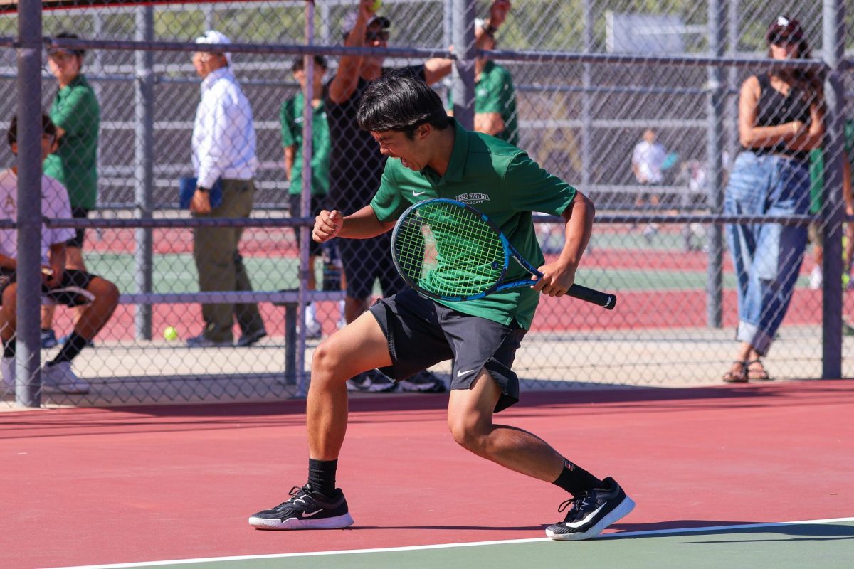 6 RJ Buenviaje ('26) roars with victory after earning the winning point in his 6-0 match against Arlington's No. 3