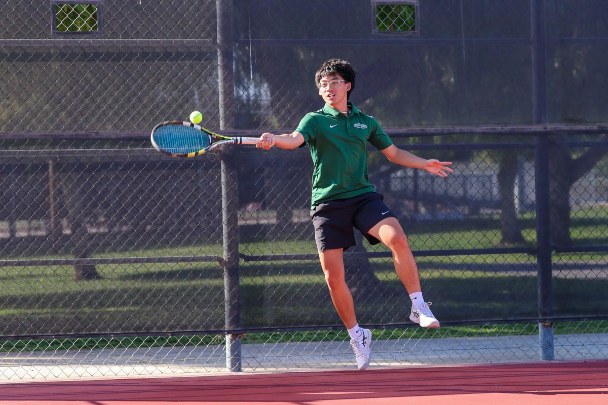 7 Caleb Yi ('27) jumps to return a lob from the Lions' No. 3